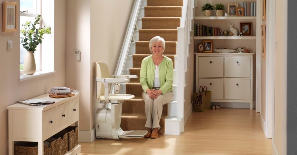 old lady on a staircase with a stairlift